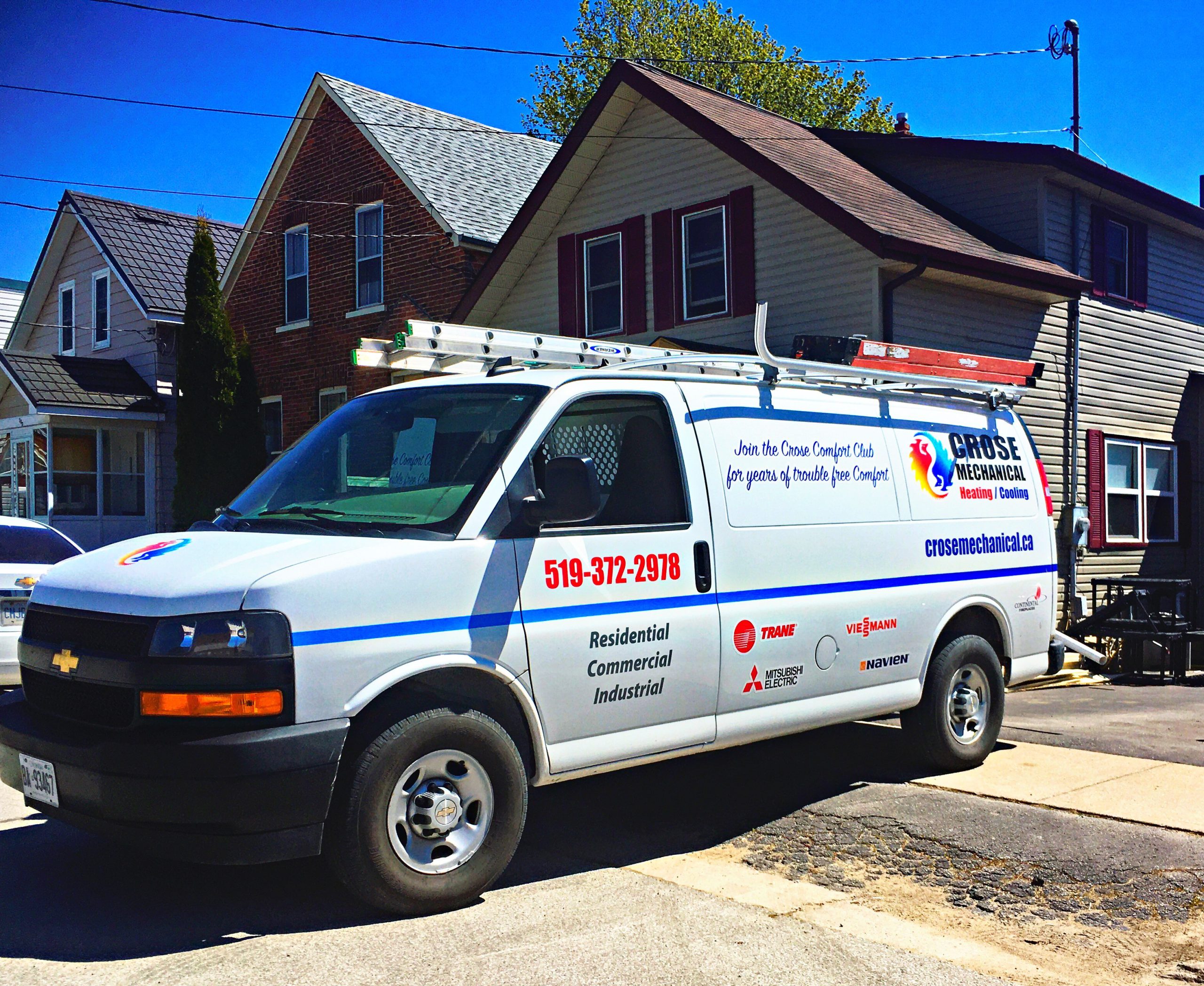 Crose Mechanical branded service van parked outside a home